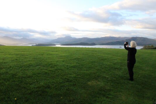 An image of a colleague taking a picture of the mountains.