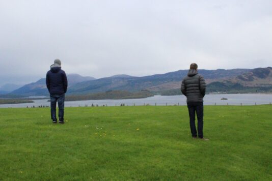 Two colleagues standing looking at the incredible views. 