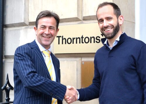 Callum Murray, CEO shaking hands with member from Thorntons.