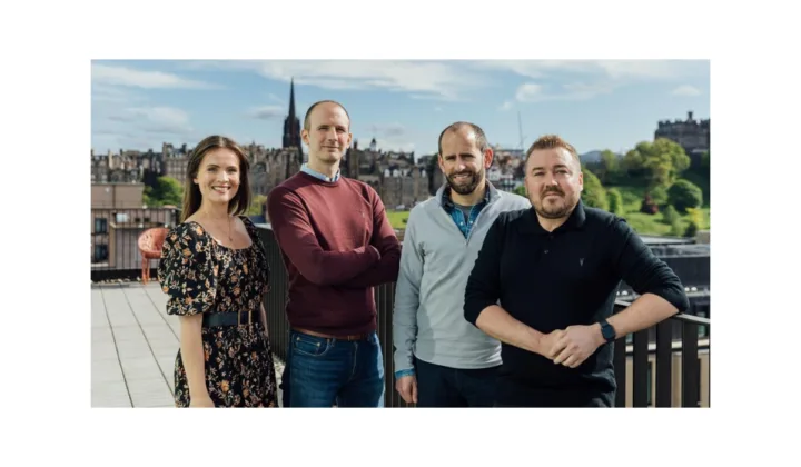 Image of the Amiqus team announcing partnership with AMLify with a member from the organisation.