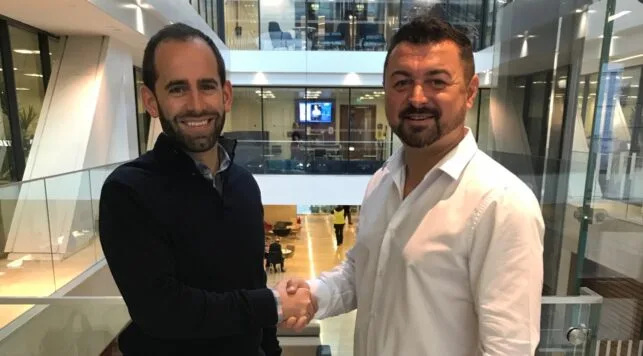 CEO Callum Murray shaking hands with a member from The Law Society of Scotland to renew partnership.