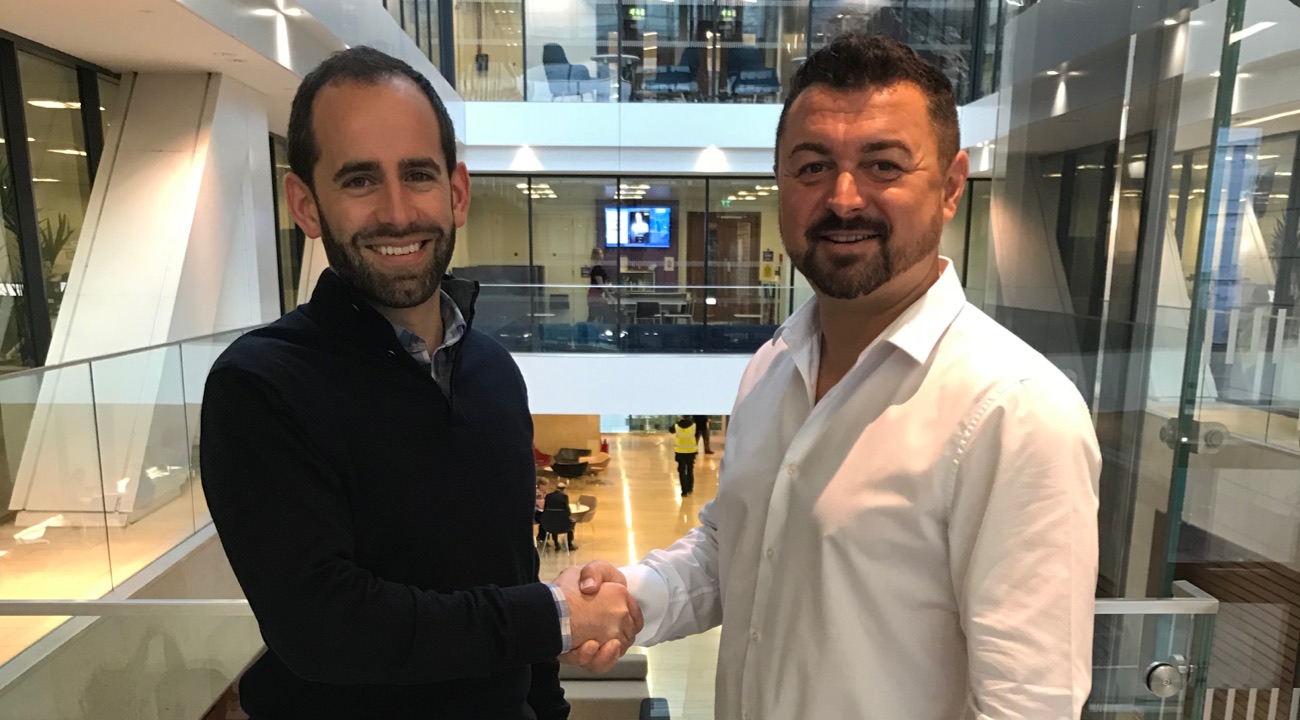 CEO Callum Murray shaking hands with a member from The Law Society of Scotland to renew partnership.