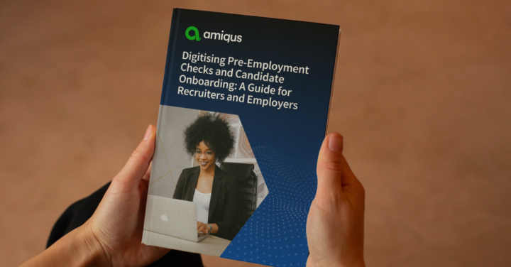 A pair of hands holding the Digital Pre-Employment Checks and Onboarding Guide by Amiqus