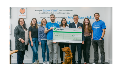 Amiqus CEO Callum Murray and team handing over a cheque of £35k to Dr Sabir Zazai, Chief Executive of the Scottish Refugee Council at their office in Glasgow