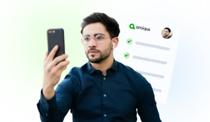 a man scanning has face on his phone for mandatory right to work checks with an Amiqus checklist in the background