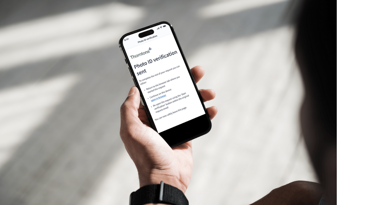 Person on mobile phone submitting ID verification to Thorntons via Amiqus